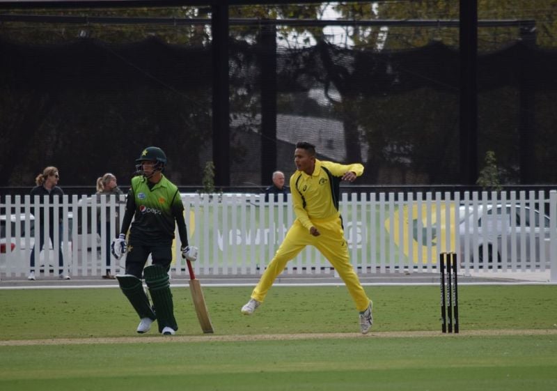 Tanveer Sangha bowling in an Under-19 match