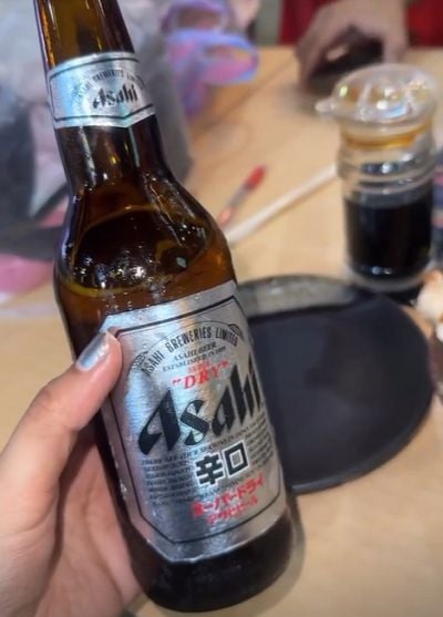 Tanya Bhushan with a bottle of beer