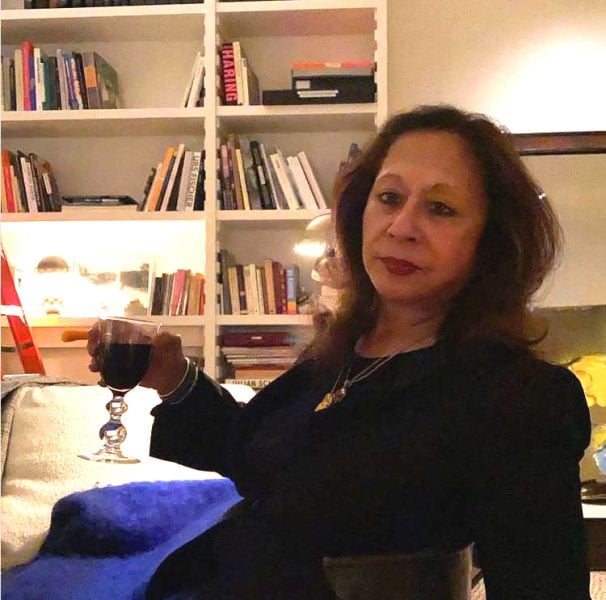 Tavleen Singh holding a glass of wine