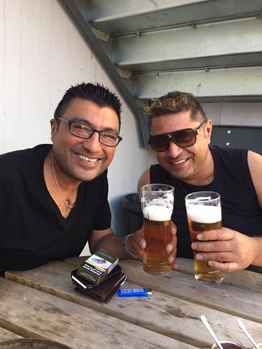 Taz holding a glass of beer