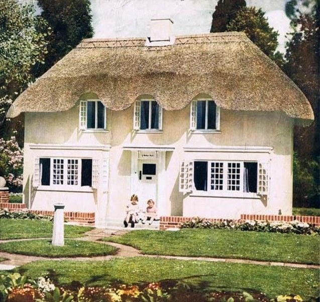 The Queen and Princess Margaret sitting outside their playhouse, 