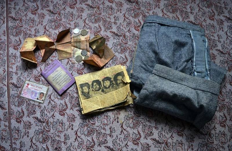 The blood-stained belongings of Abdul Qadir Sheikh kept by her wife, Afra Jan - captured by Masrat Zahra