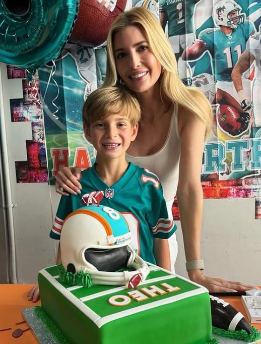 Theodore James Kushner posing with his mother and American football cake
