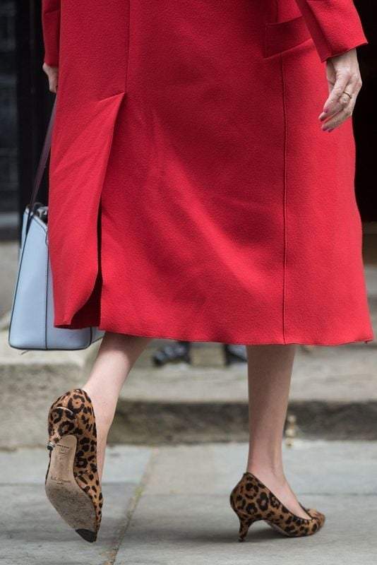 Theresa May in a red Jacket and Leopard shoes