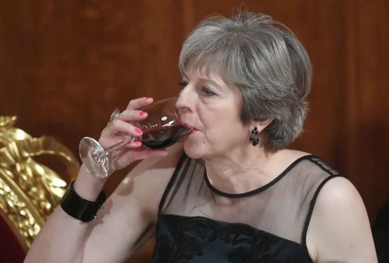 Theresa May sipping wine