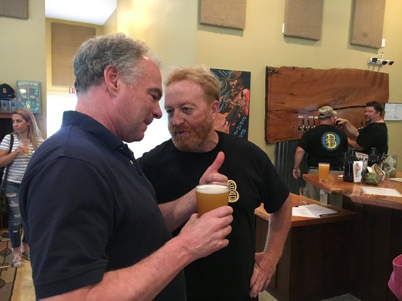 Tim Kaine holding a glass of beer