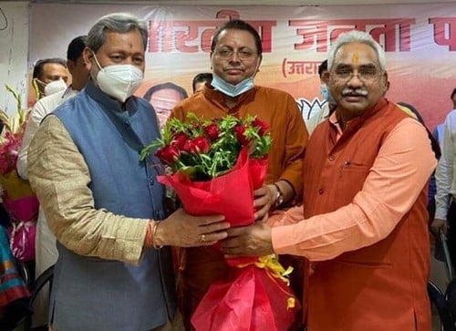 Tirath Singh Rawat (left) with Pushkar Singh Dhammi (center)