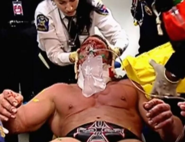 Triple H being taken to a hospital after the injury