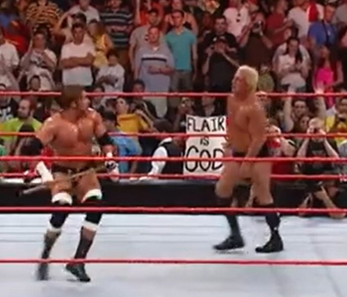 Triple H attacking Ric Flair with a sledgehammer