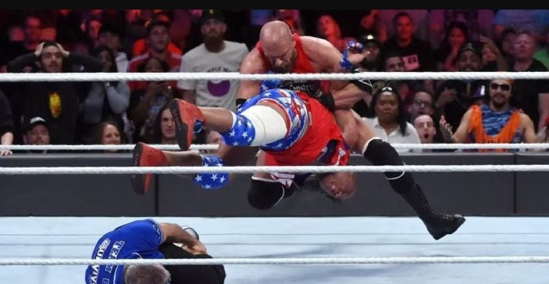 Triple H performing his signature move Pedigree on Kurt Angle during Raw vs SmackDown! event