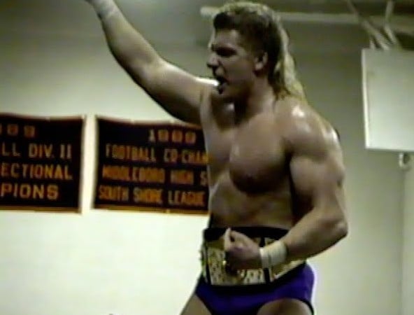 Triple H wearing his IWF Heavyweight Championship belt around his waist