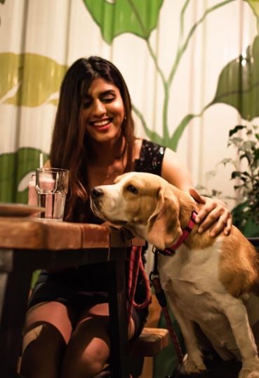 Trisha Shetty posing with a dog