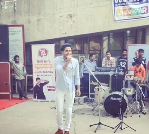 Tyson Sidhu singing during his college fest