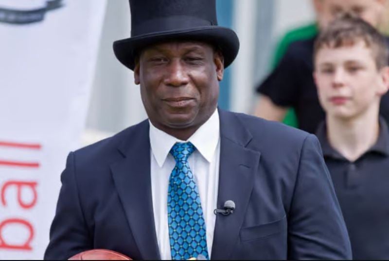 Uriah Rennie refereeing along the sidelines during a historic 