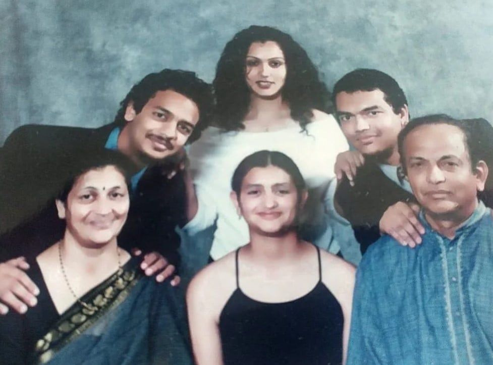 Urmila Rosario (in black, centre) with her family