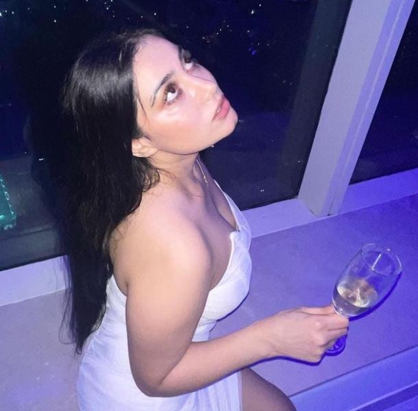 Urusa Javed holding a glass of alcohol