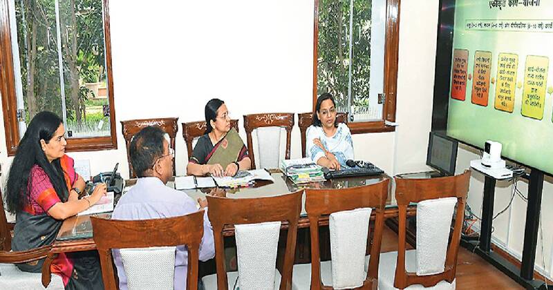 Usha Sharma presiding over a meeting