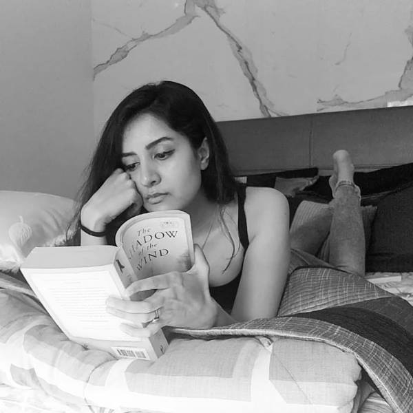 Utsavi Jha reading the book The shadow of the wind by Carlos Ruiz Zafón