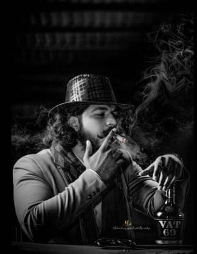 Vaibhav Chavan while smoking a cigar and posing with a bottle of alcohol