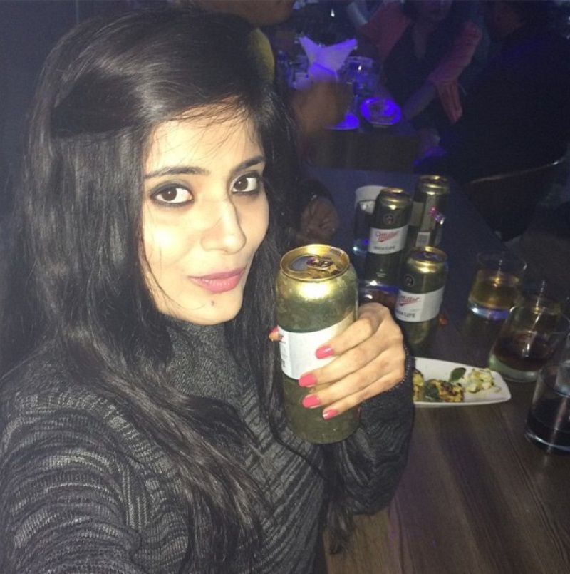 Vaishali Takkar holding a beer can