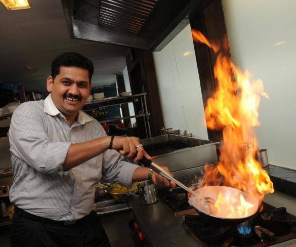 Vankatesh Bhat cooking food in a restaurant