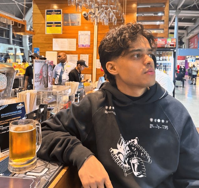 Vanshaj Singh drinking a beer