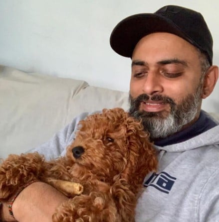 Vasi Sachi posing with his pet dog