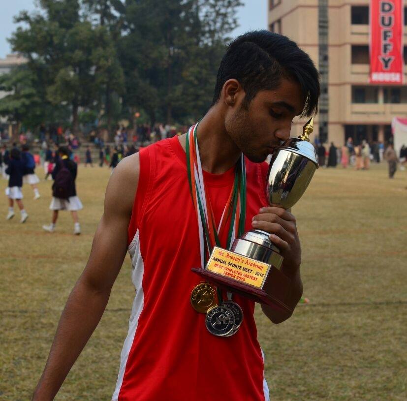 Vichaar with a trophy after winning an sports event during his school days