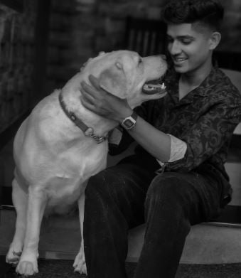Vignesh Puthur playing with a dog