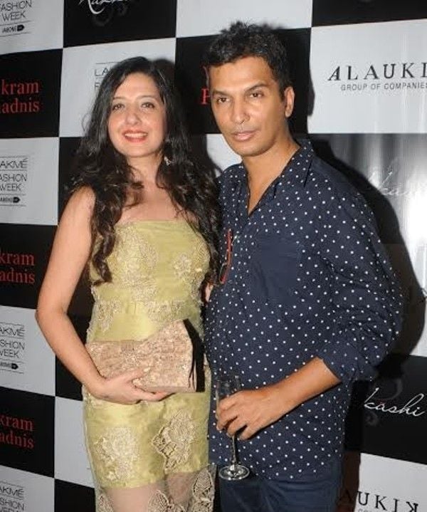 Vikram holding a glass of wine