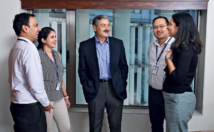 Vinay Razdan (center) while talking to his colleagues