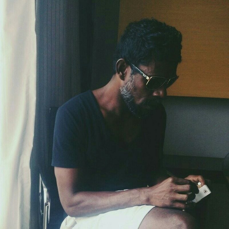 Vinayakan holding a cigarette pack