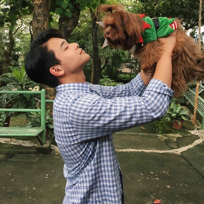 Vince Maristela holding a Lhasa Apso