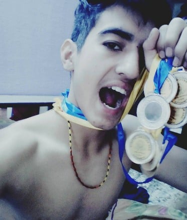 Vinod Bhatt posing with his medals