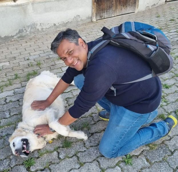 Vishnu Som posing with a dog