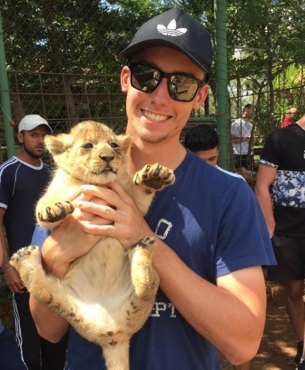 Will Jacks with a tiger cub during a visit to a wildlife park