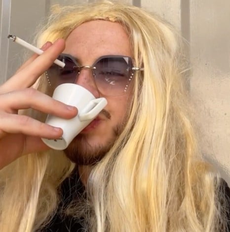 Xum Allushi while smoking a cigarette