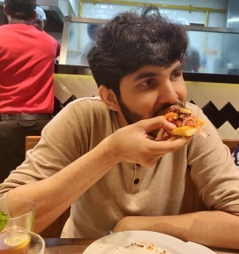 Yahya Bootwala while enjoying a pizza