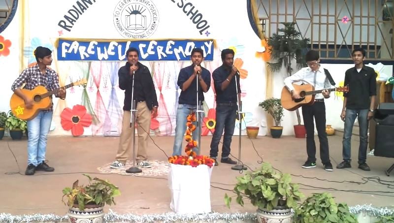 Yechan C. Lee playing guitar (second from right) during his farewell party at Radiant International School, Patna