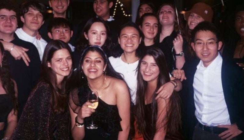 Zanai Bhosle posing with a glass of alcohol