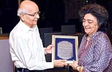 Zia while receiving Award from the Baha’i community on International Women