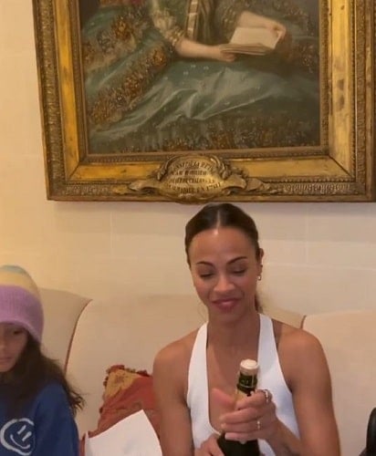 Zoe Saldaña holding a bottle of alcohol