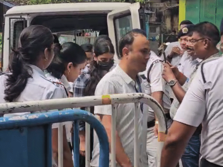 Sharmishta Panoli (wearing black mask) after being arrested by the police