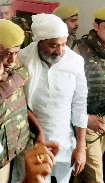 Ashraf Ahmed being taken out of court after a hearing