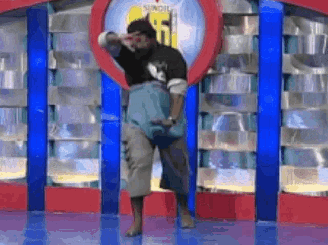 a man is standing on a stage in front of a sign that says sundial